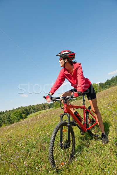 Stock photo: Young woman with mountain bike in spring nature