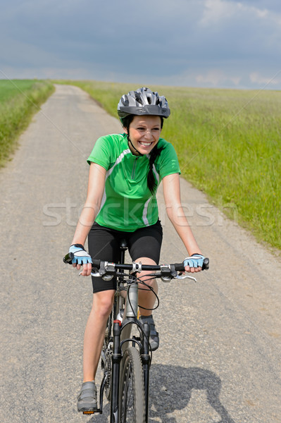 Woman riding bike on cycling path meadow Stock photo © CandyboxPhoto