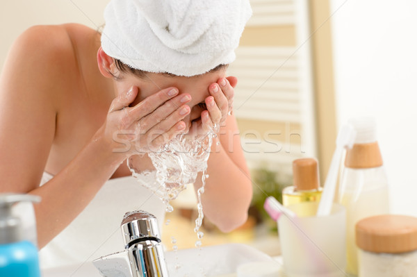 Woman splashing face with water in bathroom Stock photo © CandyboxPhoto