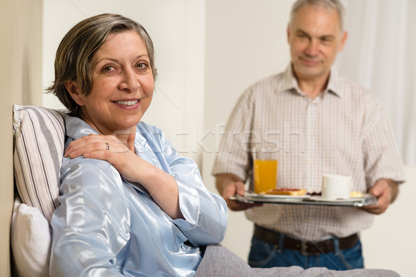 Caring senior man bringing breakfast to wife Stock photo © CandyboxPhoto