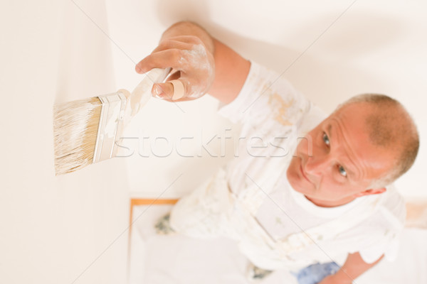 Home decorating mature man painting wall brush Stock photo © CandyboxPhoto