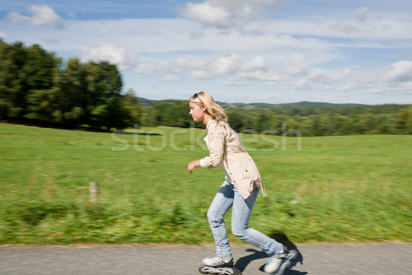 Inline skating young woman speed workout sunny day Stock photo © CandyboxPhoto
