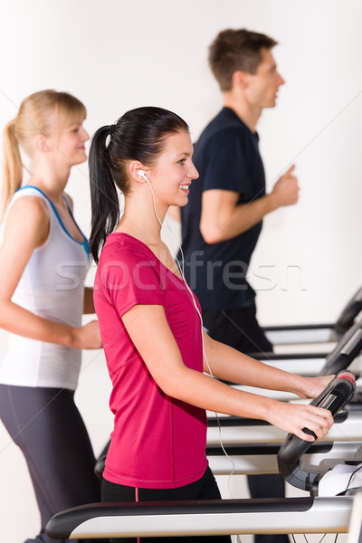 Stock photo: Young people on treadmill running exercise