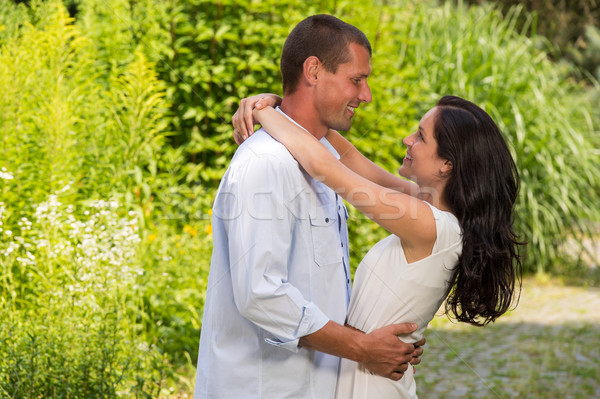 Stock photo: Playful Caucasian couple embracing outdoors