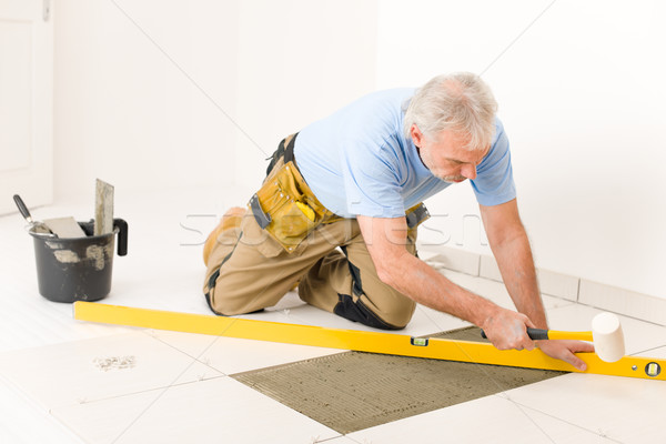 Home improvement, renovation - handyman laying ceramic tile  Stock photo © CandyboxPhoto