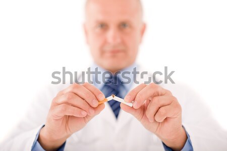 Stock photo: Stop smoking mature male doctor break cigarette