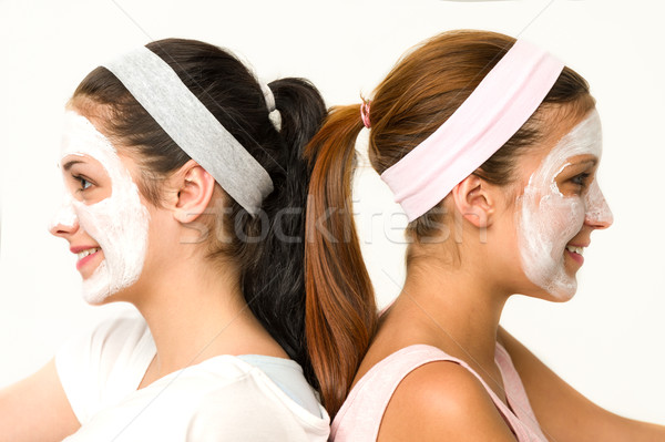 Girls sitting back-to-back wearing facial mask Stock photo © CandyboxPhoto