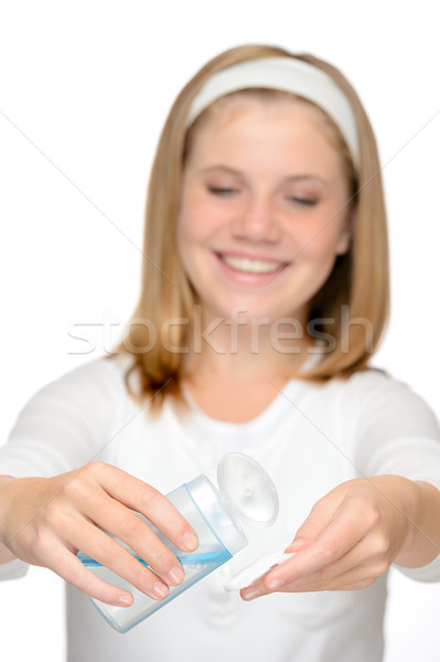 Young smiling girl applying face cleaning lotion Stock photo © CandyboxPhoto