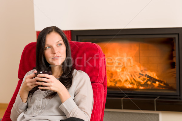 Invierno casa chimenea mujer beber caliente Foto stock © CandyboxPhoto