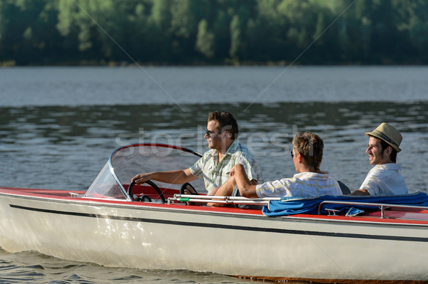 Men driving speed boat enjoying sunshine Stock photo © CandyboxPhoto