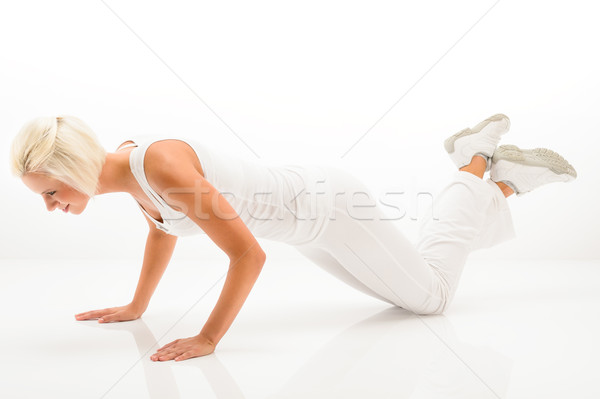 Stock photo: Woman exercise pushup at white fitness outfit