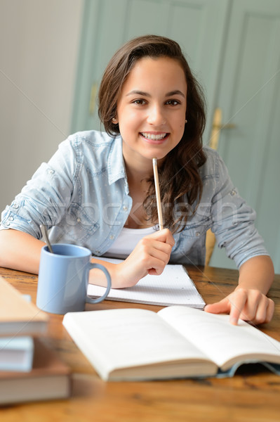 Student teenage girl studying at home smiling Stock photo © CandyboxPhoto