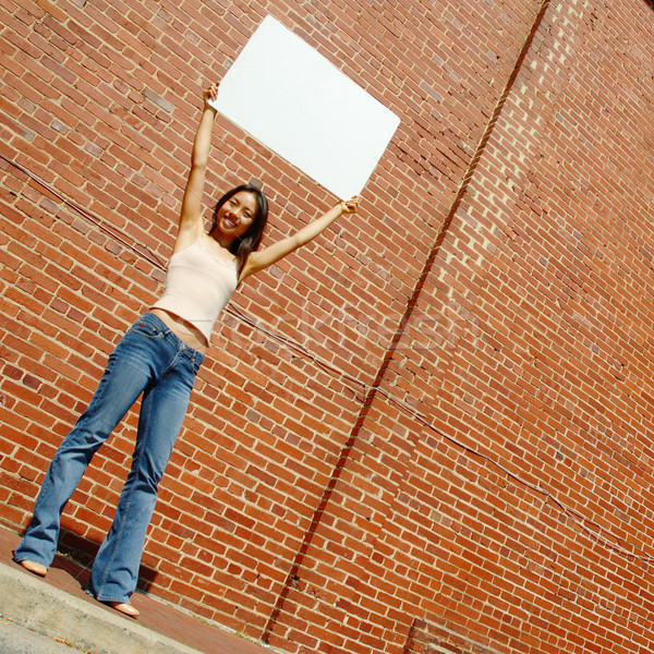 Sexy girl anunciante de moda nina blanco pared de ladrillo Foto stock © cardmaverick2
