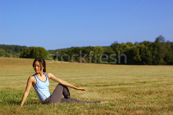 Girl Practicing Yoga In Field Stock photo © cardmaverick2