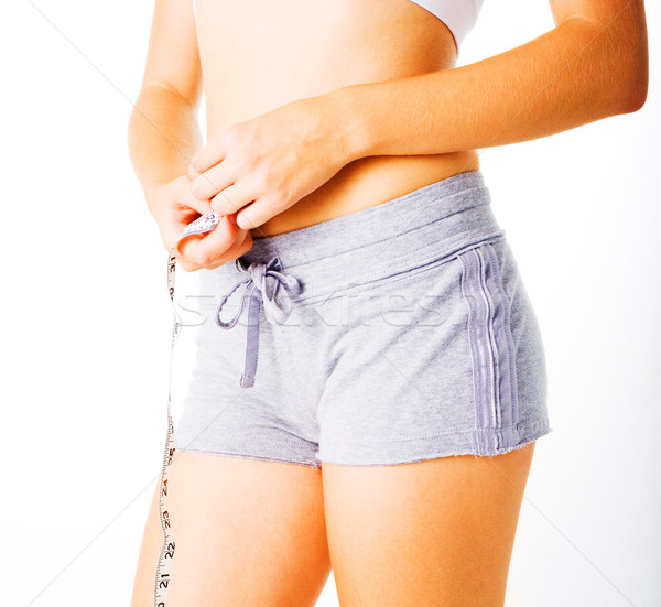 Young Woman Measuring Herself On White Stock photo © cardmaverick2