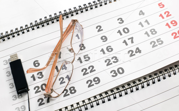 Eyeglass on calendar to schedule plans Stock photo © carenas1
