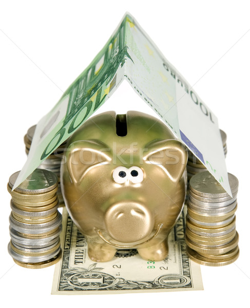 A golden moneybank under house made from banknote Stock photo © carenas1
