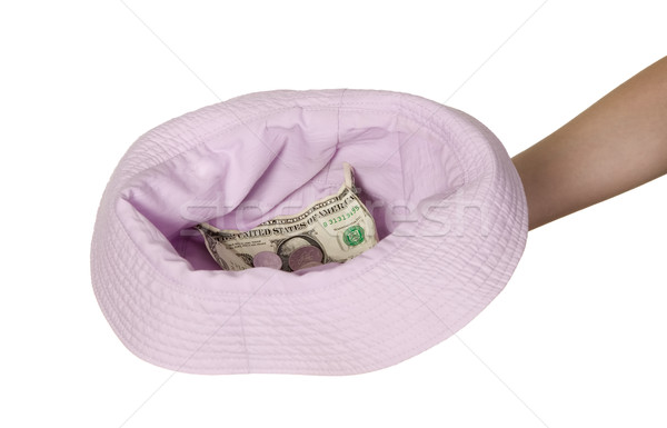 Dollars placed on cap which is held by man Stock photo © carenas1