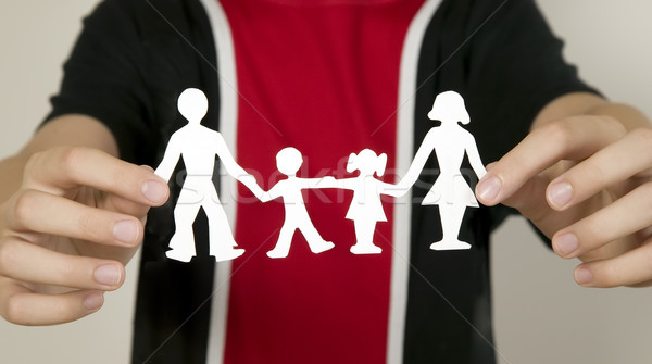 Child is holding family figures made from paper Stock photo © carenas1