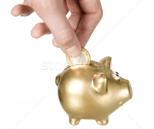 Man is putting coin to golden money box Stock photo © carenas1