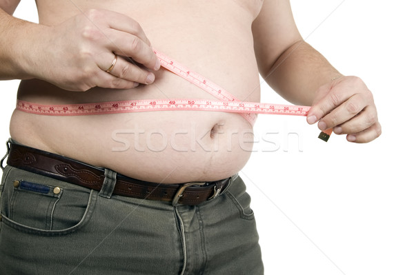 Man is measuring his belly Stock photo © carenas1