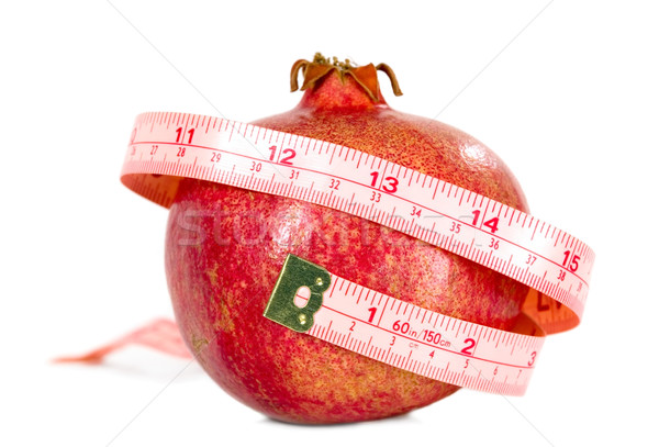 Tasteful fruit garnet with measuring tape Stock photo © carenas1