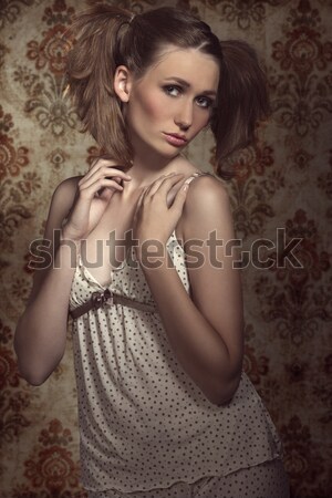 Stock photo: sensual and cute girl relaxing on golden silk