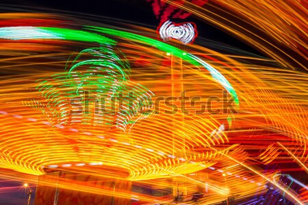 Carousels at night Stock photo © castenoid