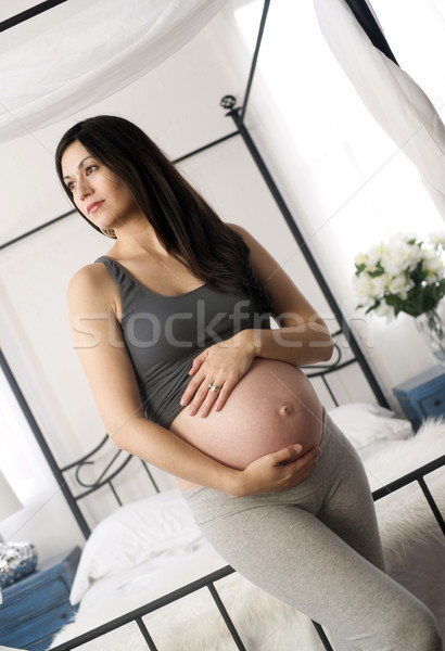 Brunette Woman Smiling Shows Pregnant Belly Standing Near Canopy Stock photo © cboswell