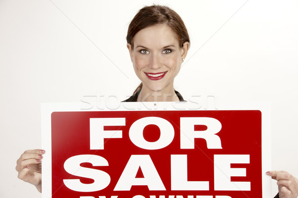 Attractive Female Realtor Holds up the For Sale Sign Stock photo © cboswell