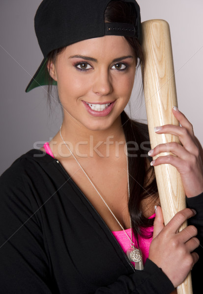 Pretty Female Baseball Lover Holds A Wooden Bat and Smiles Stock photo © cboswell