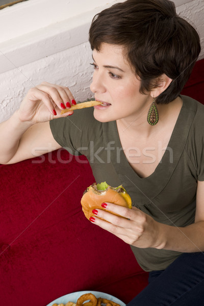 Woman Eating Burger Fries Lunch Sofa Living Room Meal Time Stock photo © cboswell