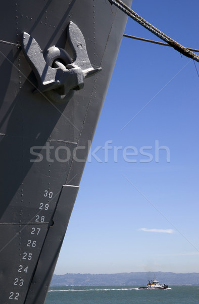 Huge Ship Bow and Anchor Tugboat Passing in Bay Underneath Stock photo © cboswell