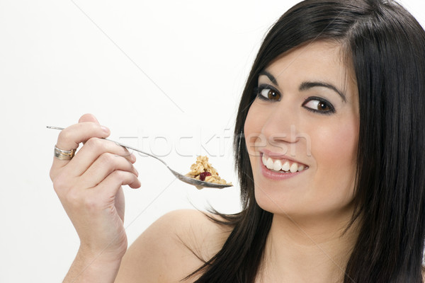 Smiling Young Adult Woman Eats Cereal With Fruit Stock photo © cboswell