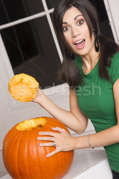 Excited Happy Woman Cutting Carving Halloween Pumpkin Jack-O-Lan Stock photo © cboswell