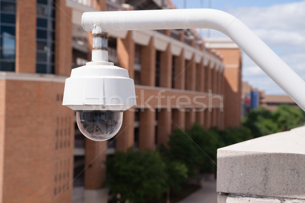Video Security Camera Housing Mounted High on College Campus Stock photo © cboswell