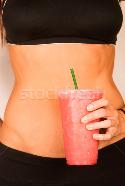 Slender Female Torso Tanned Toned Body Blended Fruit Smoothie Drink Stock photo © cboswell