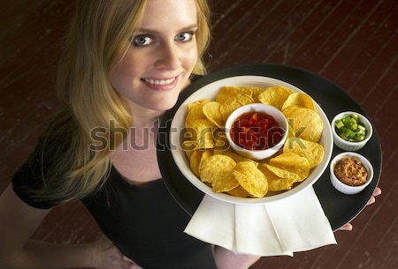 Genç çekici kadın Sunucu tepsi cips salsa Stok fotoğraf © cboswell