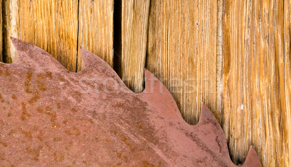 Rusty Sawblade Against Wood it Was Designed to Cut Stock photo © cboswell
