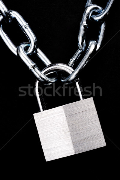 Link Chain Connected By Keyed Steel Locking Padlock on Black Stock photo © cboswell