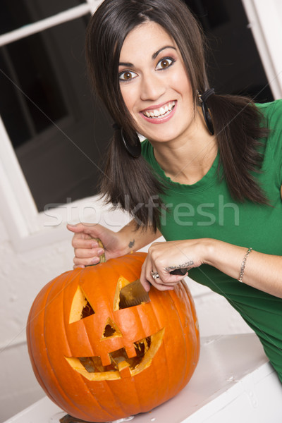 Excited Happy Woman Cutting Carving Halloween Pumpkin Jack-O-Lan Stock photo © cboswell