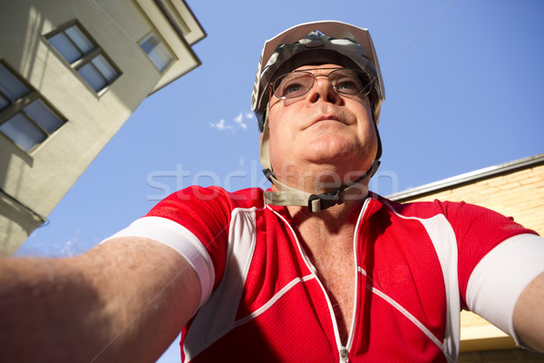 Mature Man Rides Bicycle Downtown Seen from Low Angle Stock photo © cboswell