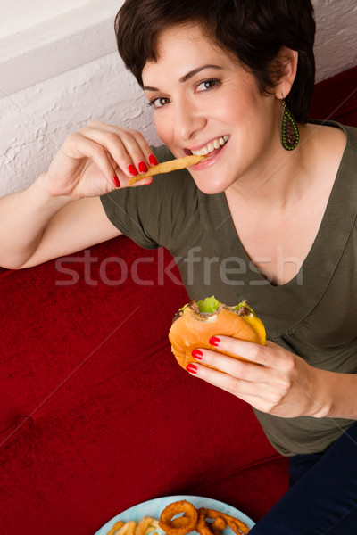 Happy Healthy Young Adult Woman Eats Fast Food Cheesburger Lunch Stock photo © cboswell