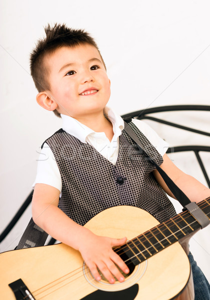 Young Boy Jamming Full Size Guitar Gritting Teeth Playing Musici Stock photo © cboswell