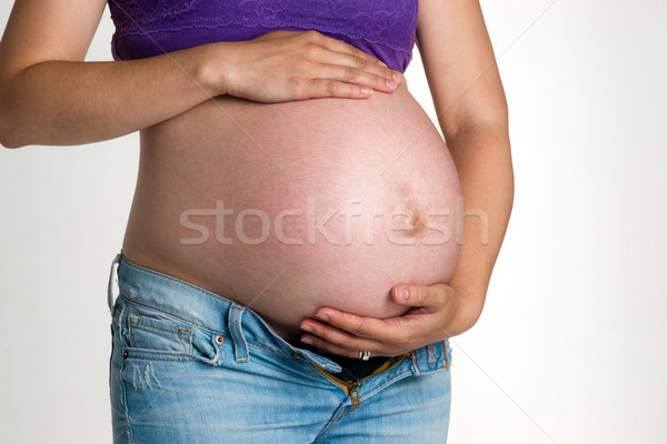 Pregnant Woman Expecting Baby Torso Standing Hands on Belly Stock photo © cboswell