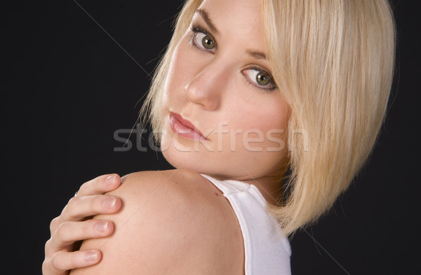 Young Vibrant Blond Woman Looks over Her Shoulder in Headshot Stock photo © cboswell
