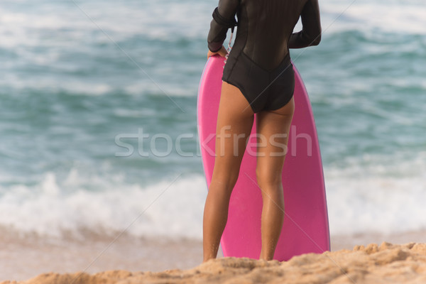 Female Surfer Stands Beach Watching Surf Waiting Pink Body Board Stock photo © cboswell