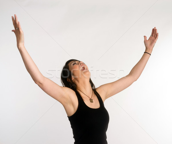 Pretty Brunette Woman Holds Arms Outstretched Jubilant Looking Up Stock photo © cboswell