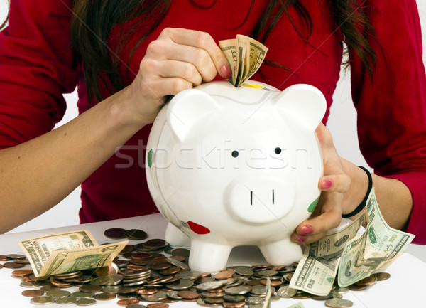 Woman Stuffing US Currency Coins Piggy Bank Cash Savings Stock photo © cboswell