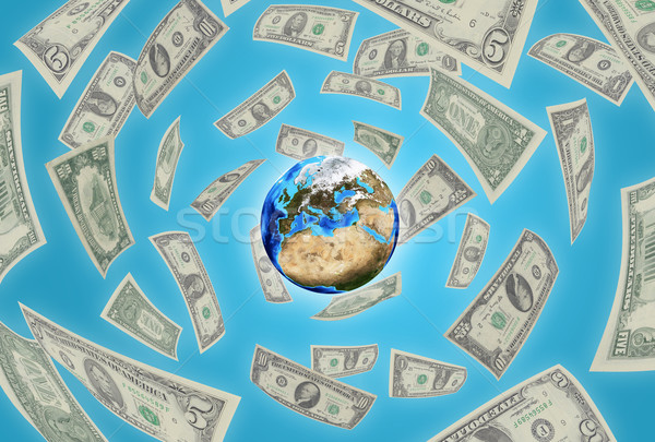 Earth on blue background. Money falling around Stock photo © cherezoff